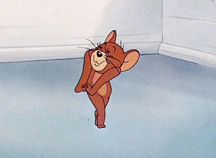 Meme Jerry cười troll khi Tom mắc kẹt cửa.