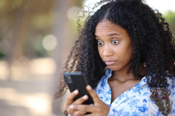 perplexed black woman checking p